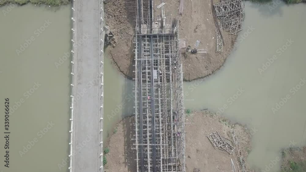 overhead drone shot of workers working on a scaffolding structure of ...