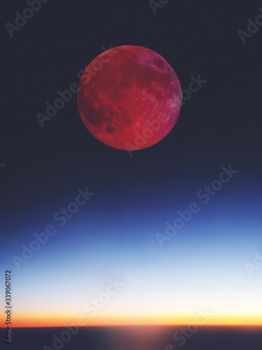 Full red bloody Moon setting   rising above the horizon.