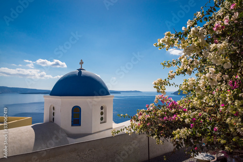 Looking over the top of an old church dome on the edge of the town of Fira on the island of Santorini, Greece
