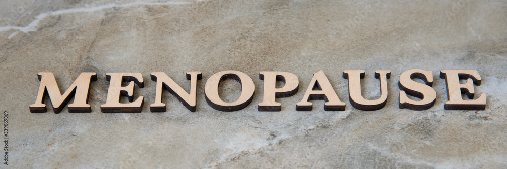 menopause , writen wooden letters on stone background menopause , writen wooden letters on stone background