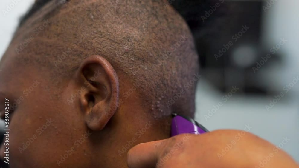 Close Up of Stylist Cutting Lines into African American Woman's Hair Close Up of Stylist Cutting Lines into African American Woman's Hair