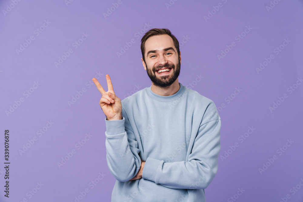 Positive happy young man showing peace gesture. Positive happy young man showing peace gesture.