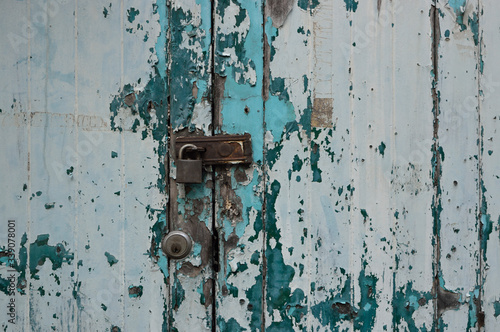 Rusted keys to lock vintage old green wood door for background