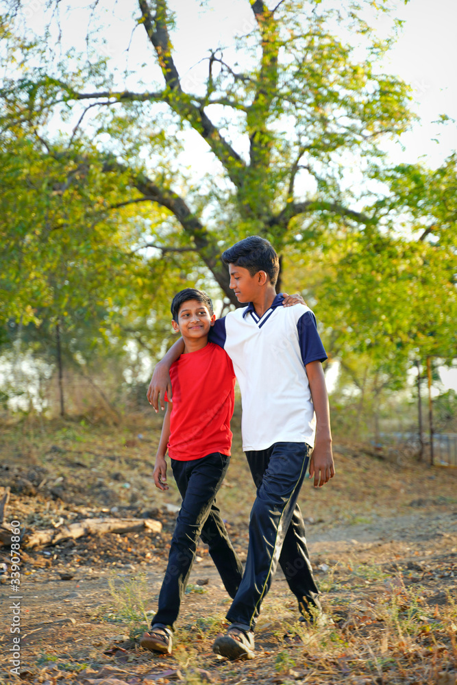 two little indian brother walking on road two little indian brother walking on road