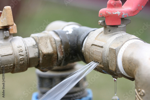 Water jet from a crack in the tap body