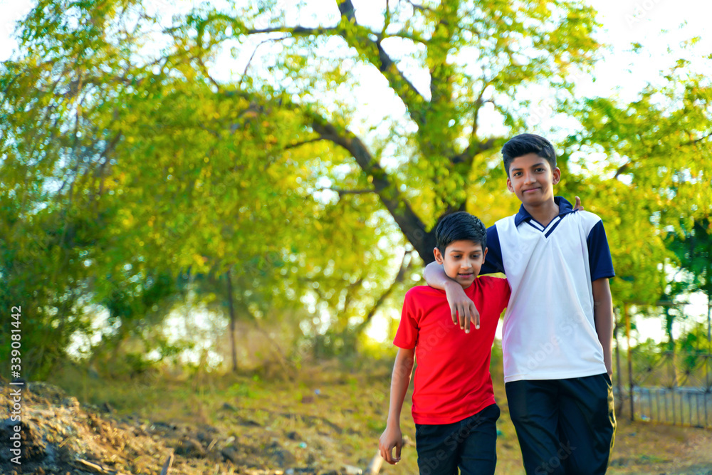 two little indian brother walking on road two little indian brother walking on road