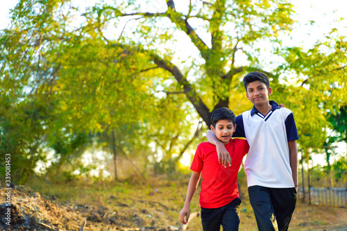 two little indian brother walking on road © PRASANNAPIX