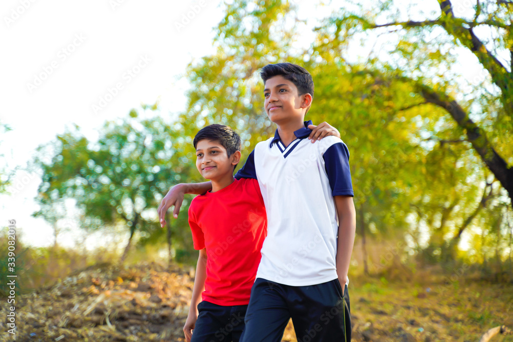 two little indian brother walking on road two little indian brother walking on road