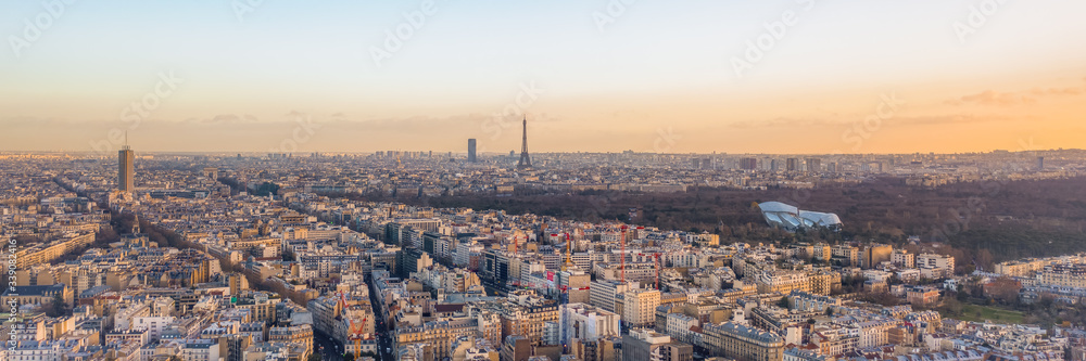 Aerial panorama drone shot of districts Neuilly sur Seine in Paris with Tour Eiffel Montparnasse Jardin acclimatation in Boulogne forests