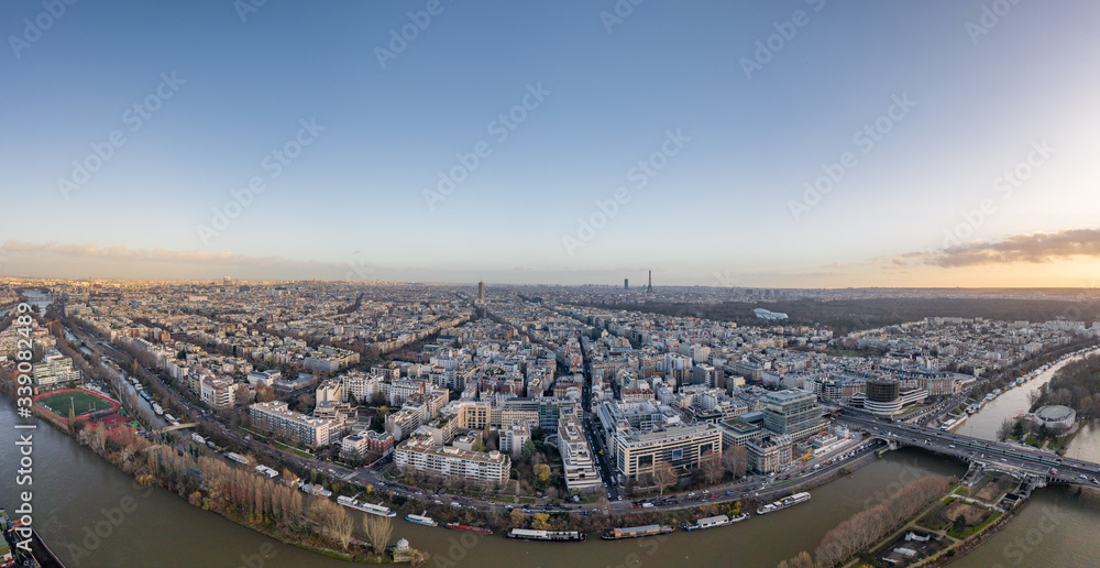 Aerial drone fisheye shot of districts Neuilly sur Seine in Paris with Tour Eiffel Montparnasse Jardin acclimatation in Boulogne forests