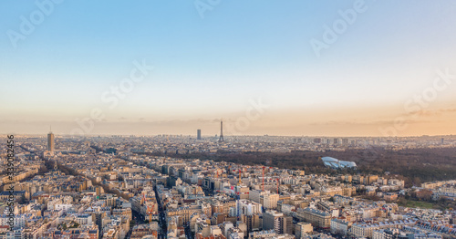 Aerial drone shot of districts Neuilly sur Seine in Paris with Tour Eiffel Montparnasse Jardin acclimatation in Boulogne forests