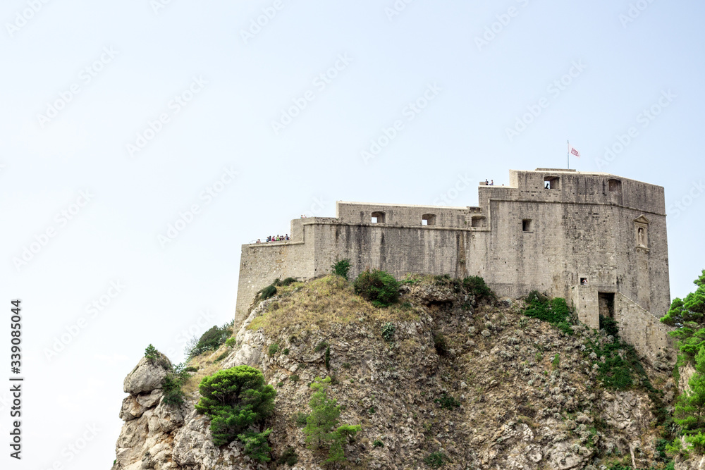 Fototapeta premium Dubrovnik old town city view, old castle view, Ancient fortress view and houses, a castle on the sea bay, hand made walls build with old bricks and stones, Croatia