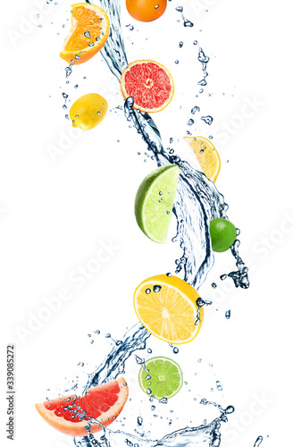 Different falling citrus fruits and splashing water on white background