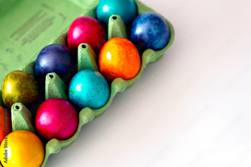 Top view of colorful eggs in the carton box on white background. Easter holiday concept with copy space. Top view of colorful eggs in the carton box on white background. Easter holiday concept with copy space.