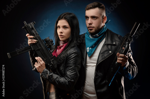 Photography a girl and a guy in a leather jacket with a gun