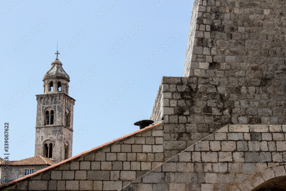 Ancient church top view, and stairs of Dubrovnik old town, hand made walls build with old bricks and stones, clock tower, bell tower, Croatia