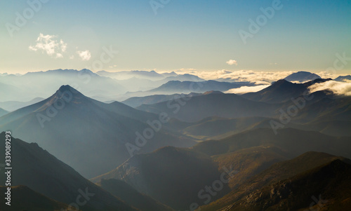 Fototapeta Naklejka Na Ścianę i Meble -  mist over mountains on a sunny evening