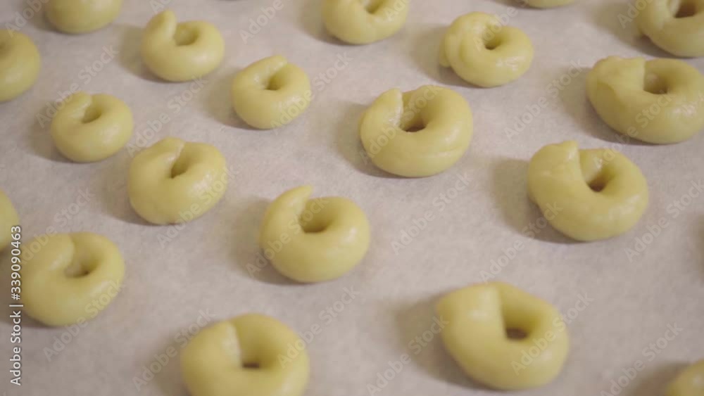 homemade rings of dough to bake taralli on a oven tray, clockwise rotation homemade rings of dough to bake taralli on a oven tray, clockwise rotation