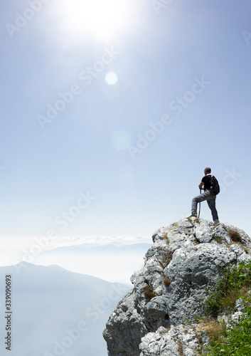 Fototapeta Hiker on the summit of a mountain