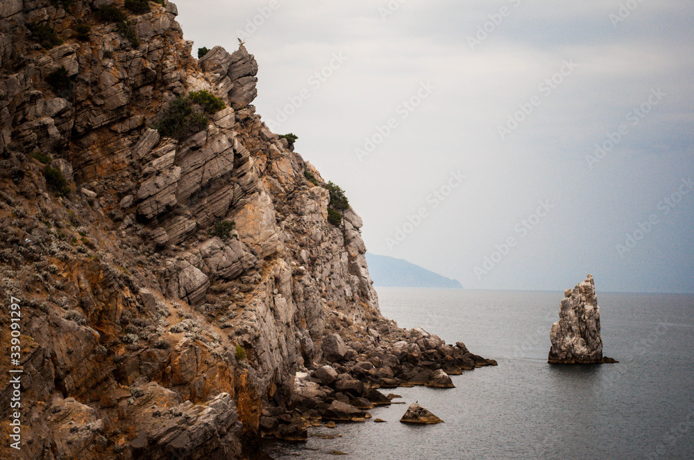 Crimean mountains. A sheer cliff against the blue sky. free space for text