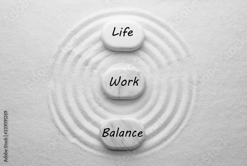 Photography Work-life balance concept. Stones on sand with pattern, flat lay