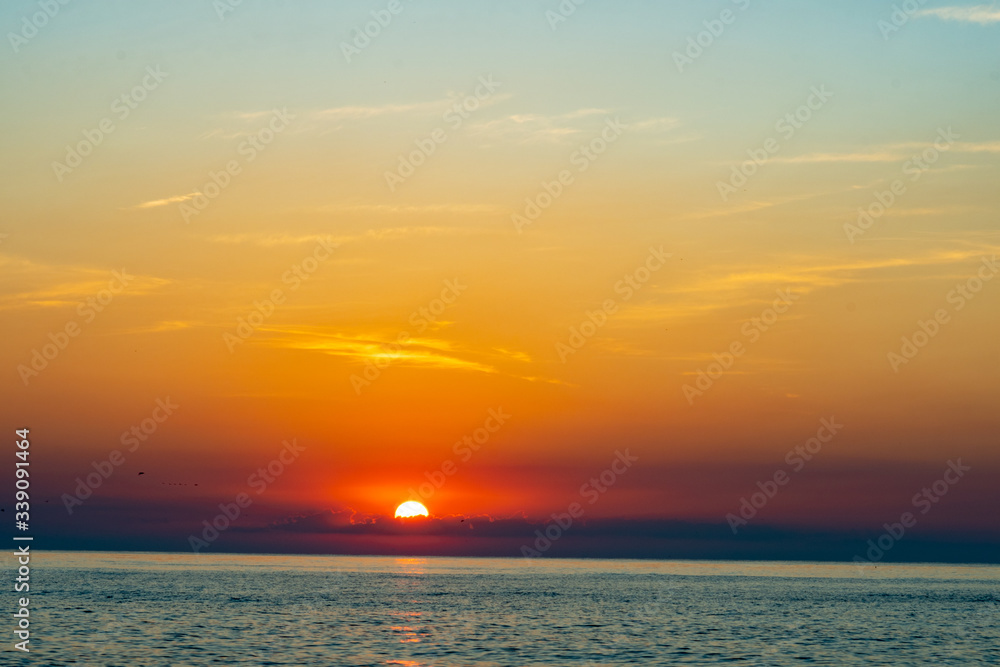sunset on the sea and the sun reflects on the water