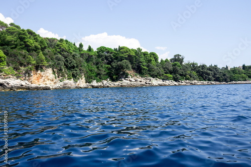 Dubrovnik sea view with the cliff and rocks sea water splashing on the rocks view from the middle of the ocean