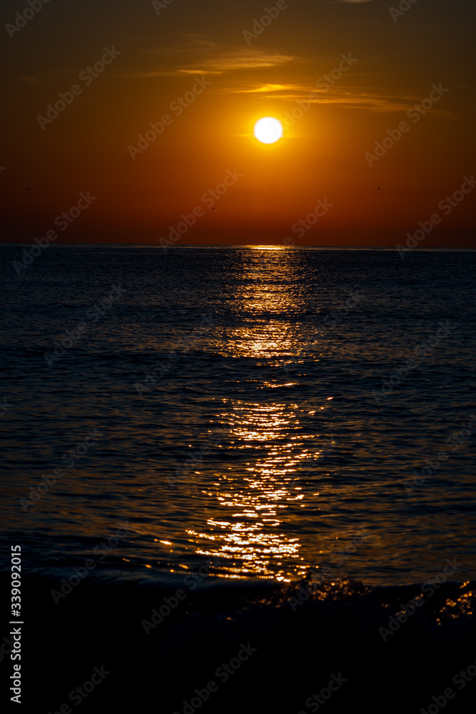 Fototapeta premium the sun reflected at sea at sunrise