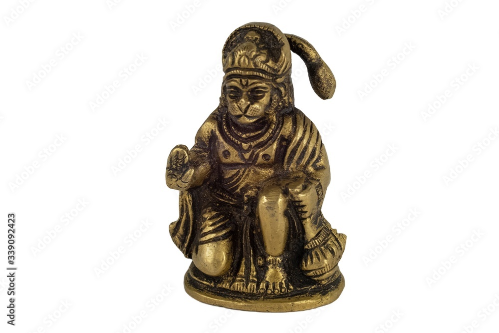 Aged yellow metal bronze statuette of Indian deity Hanuman closeup isolated on a white background