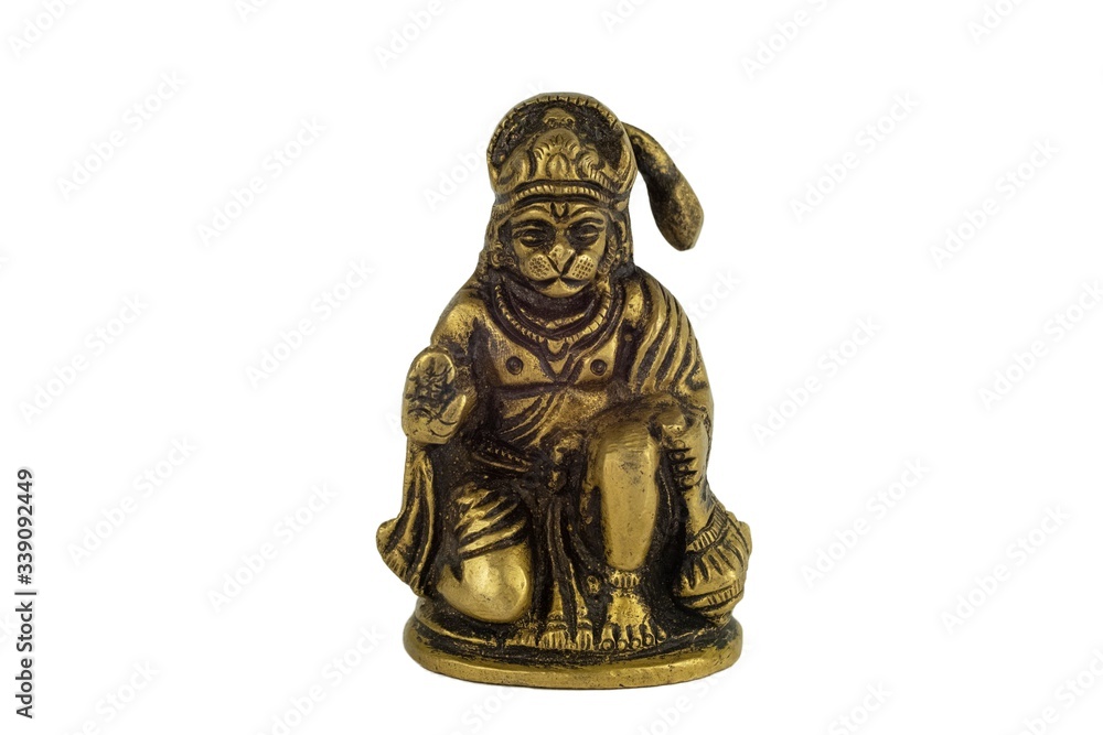 yellow metal bronze statuette of indian deity Hanuman closeup isolated on a white background
