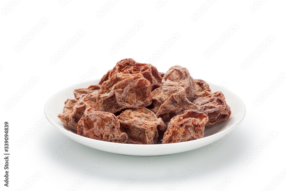 Preserved plums in a ceramic dish isolated on white background. Chinese snacks. Preserved plums in a ceramic dish isolated on white background. Chinese snacks.