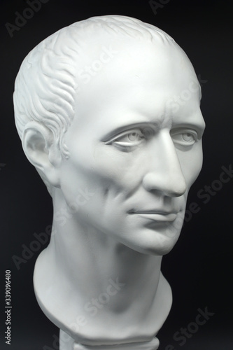 julius caesar roman emperor gypsum bust on black background