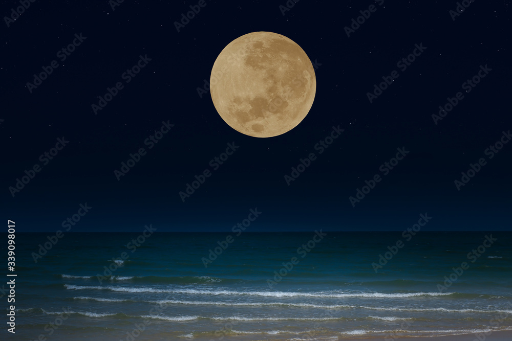 Full moon over the sea at night. Full moon over the sea at night.