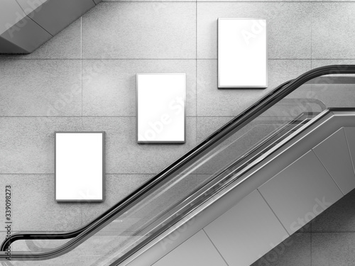 Side view of escalator on wall background with three blank light box. 3D rendering. photo