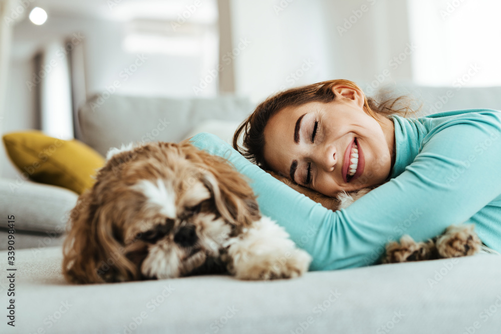 Happy woman with dog resting on the sofa. Happy woman with dog resting on the sofa.