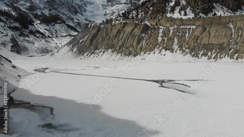 Aerial Pan Shot of melting Gangapurna glacial lake below Annapurna in Manang, Nepal photo