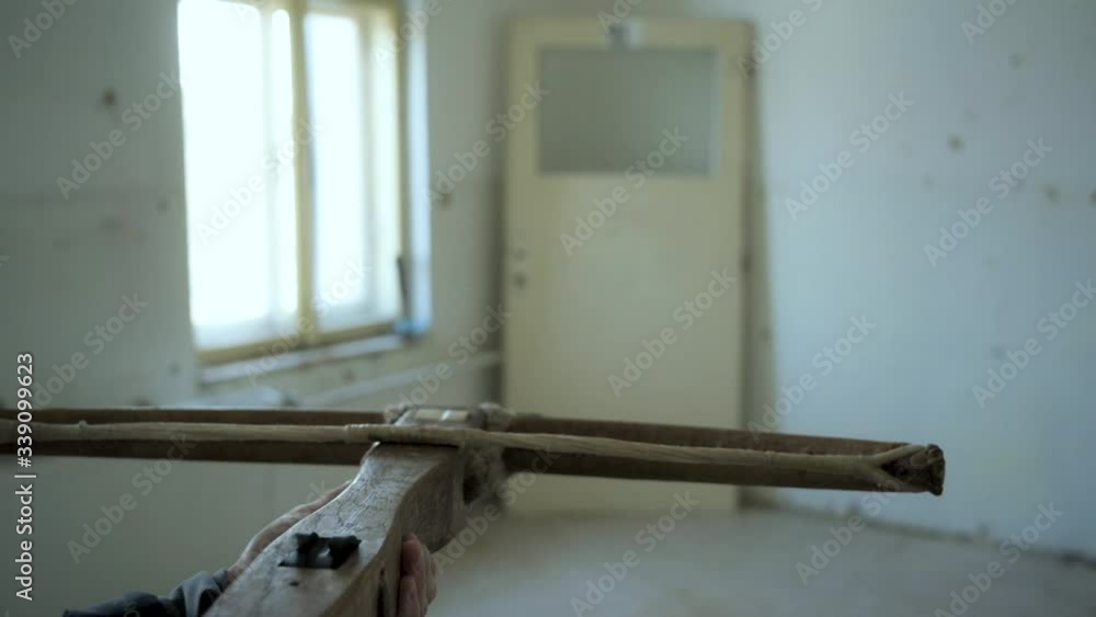 Crosbow shooting at a door in an abandoned house (slow motion) Crosbow shooting at a door in an abandoned house (slow motion)