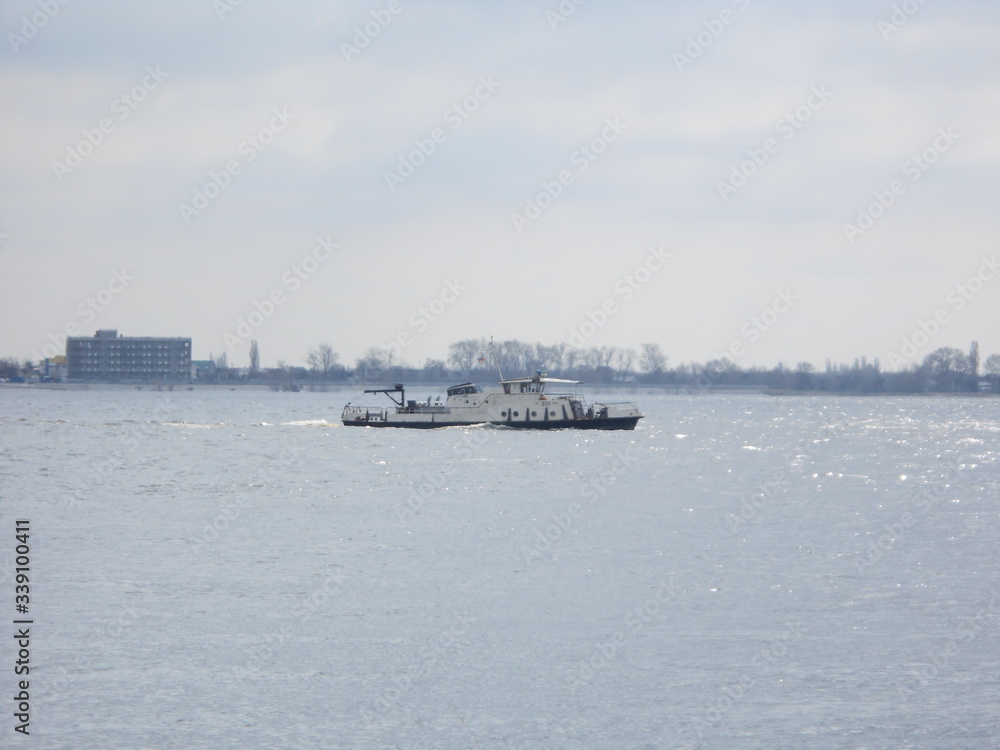 Little factory's boat on the Volga river with a waves