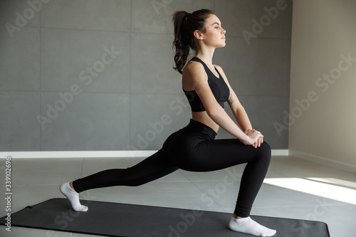 Photo of caucasian beautiful woman doing exercise while working out