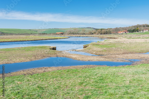 Views of Cucmere river near Seaford and Eastbourne  East Sussex  footpath leading to Cuckmere Haven beach  selective focus