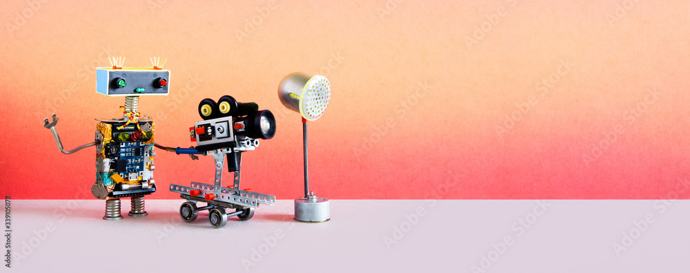 Robotic filmmaking. Funny robot cameraman operator shoots television movie  or motion picture. Automated process of creating video content. Pink gray  studio background. copy space Stock Photo | Adobe Stock