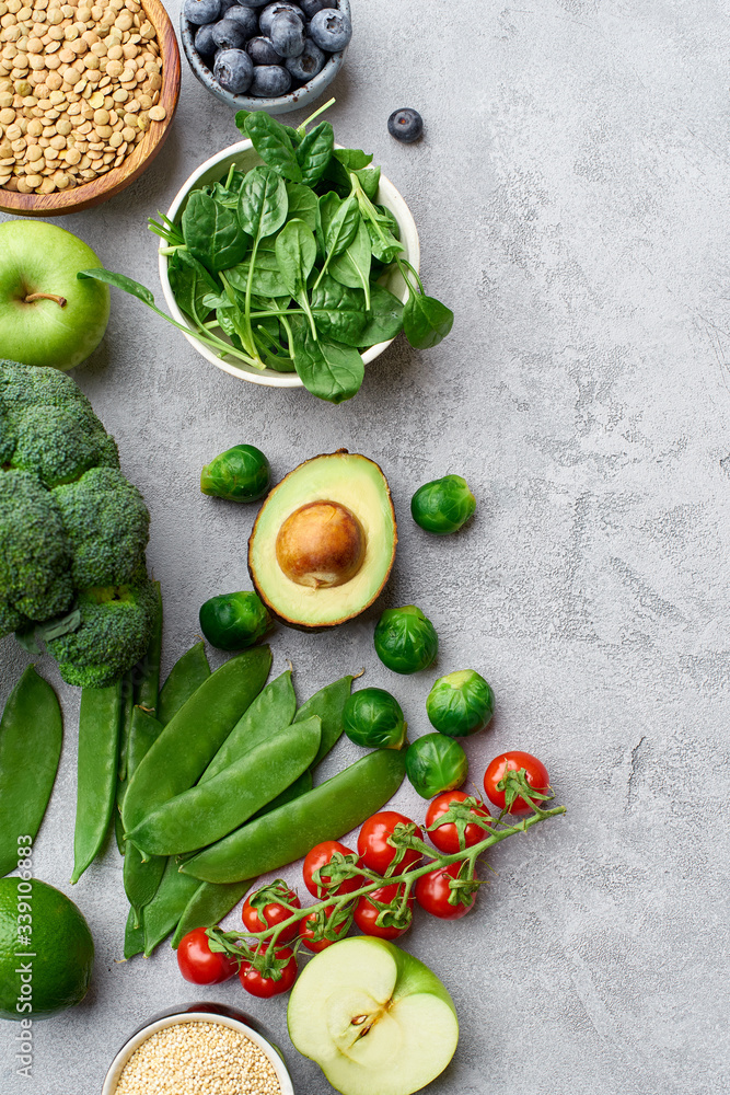 Top view flat lay with healthy vegetarian food ingredients. Raw food concept with avocado. Organic fruits and vegetables on concrete background with copy space. Top view flat lay with healthy vegetarian food ingredients. Raw food concept with avocado. Organic fruits and vegetables on concrete background with copy space.