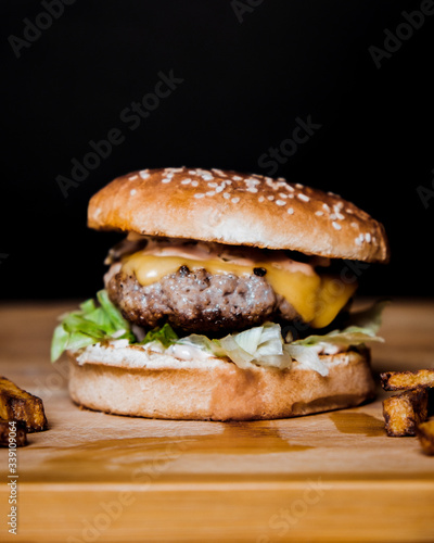 Close up of juicy burger shot on black background