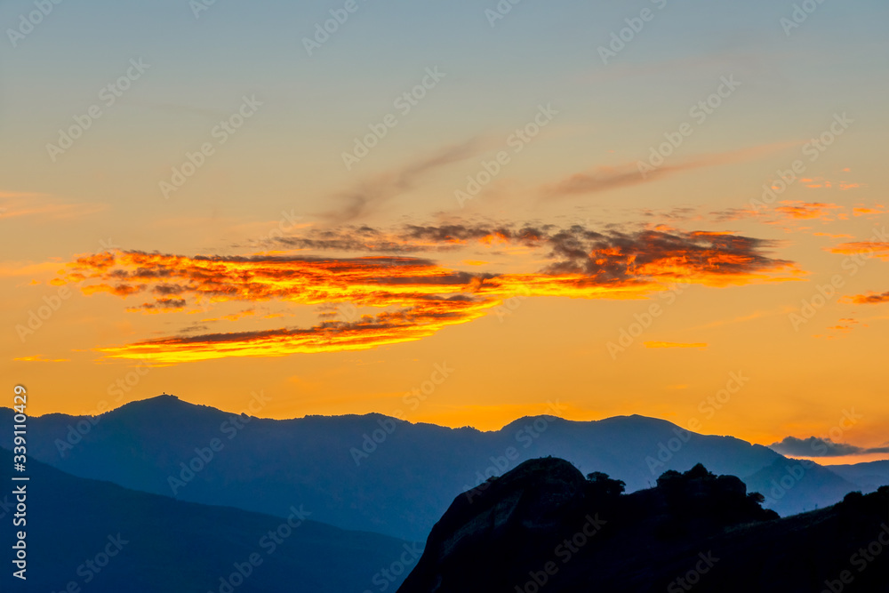 Golden Post-Sunset Sky Over the Mountain Peaks