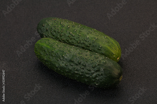 Green fresh cucumbers over background