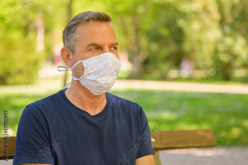 Middle-aged man relaxing wearing a face mask