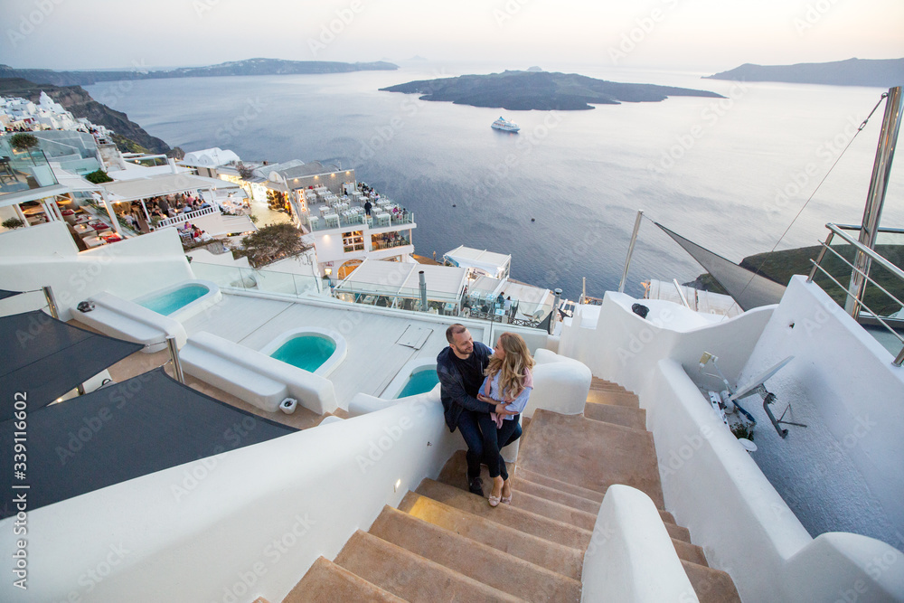 Obraz premium Romantic couple posing together on stairs of a beautiful city