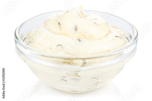Tartar sauce with onions and pickled cucumbers in a small transparent glass round bowl isolated on white background