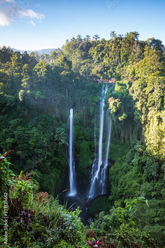 Triple waterfall in the green rainforest of Bali, Indonesia photo