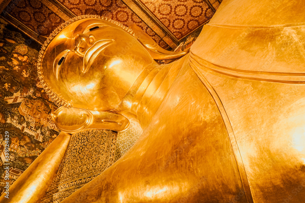 Close-up View Head Reclining Buddha famous vacation time travel place in Thailand Wat Pho.